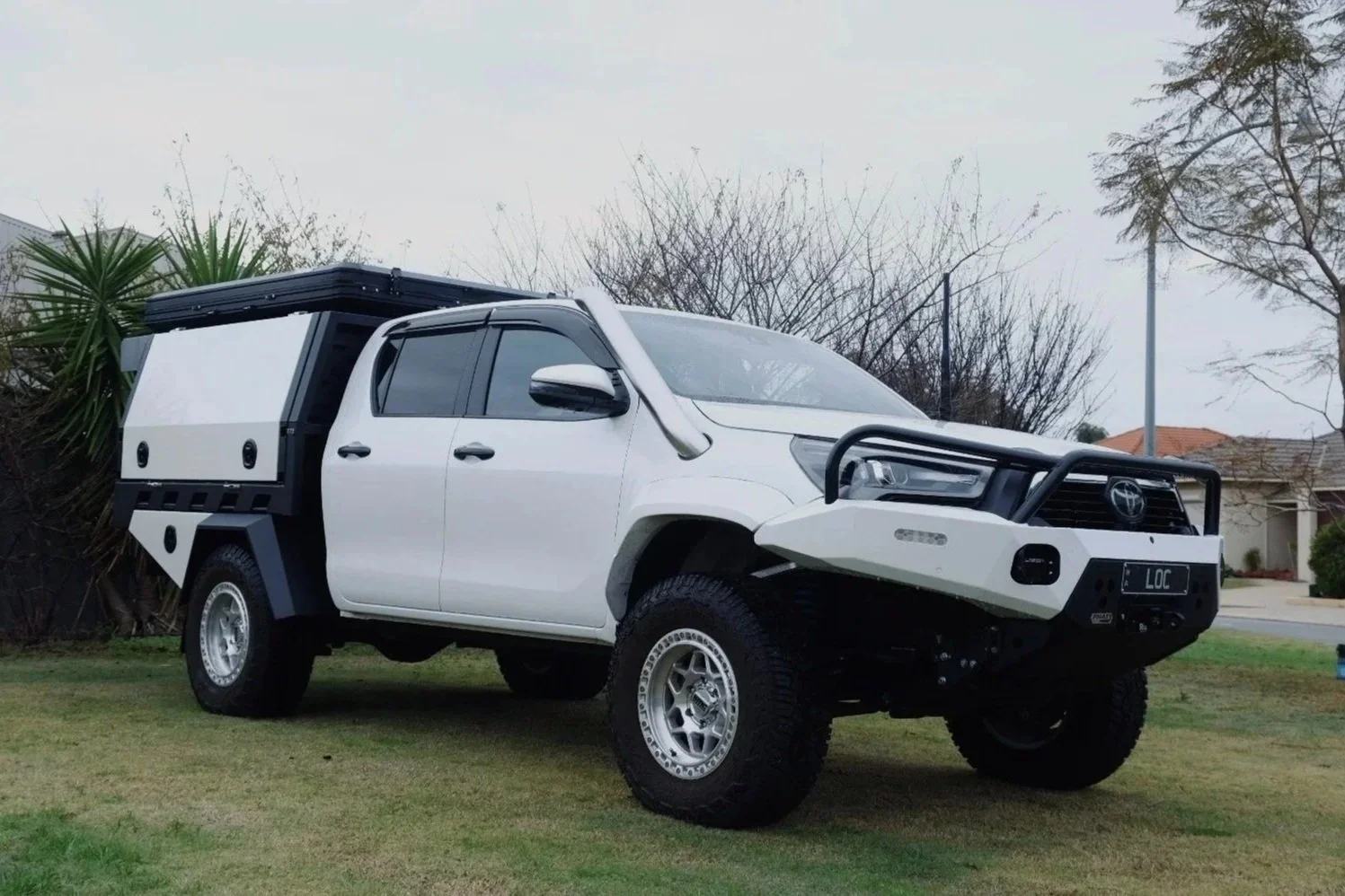White Toyota Hilux fitted with a Rep Engineering aluminium tray and canopy