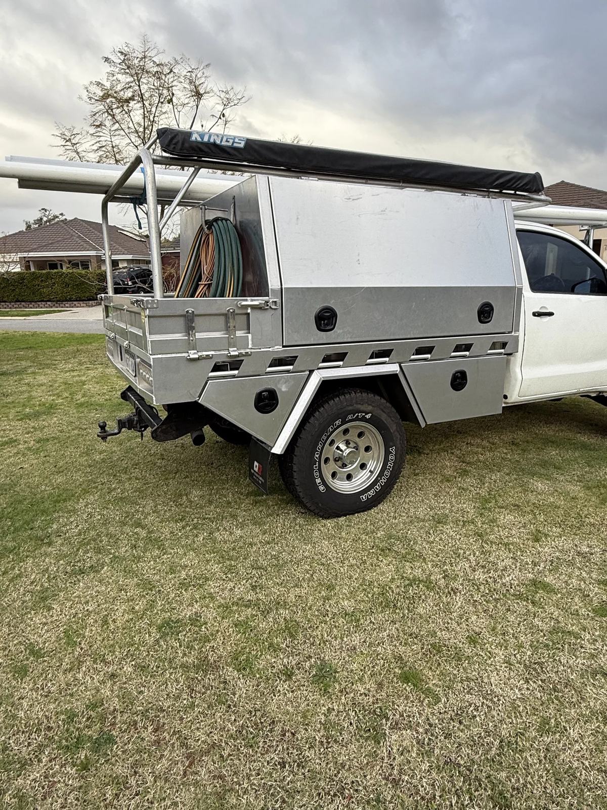 Silver tradie canopy with ladder rack and awning